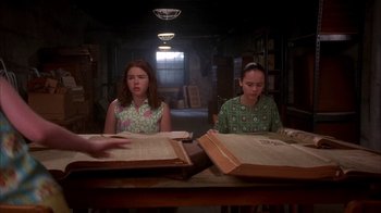 Movie still from “Now and Then” (1995), directed by Lesli Linka Glatter – Two young girls sitting at a table in front of open books; Medium shot, High angle