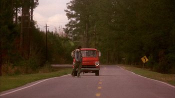 Movie still from “Now and Then” (1995), directed by Lesli Linka Glatter – A man standing on the side of a road next to a red van; Wide shot, Low angle