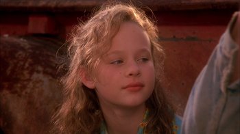 Movie still from “Now and Then” (1995), directed by Lesli Linka Glatter – A young girl with long blonde hair looking to her left; Close Up shot, High angle