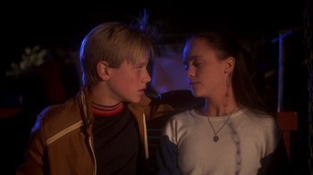 Movie still from “Now and Then” (1995), directed by Lesli Linka Glatter – A boy and a girl looking at one another; Close Up shot, Low angle