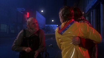 Movie still from “Now and Then” (1995), directed by Lesli Linka Glatter – A man and a woman are standing on the side of the street; Medium shot, Over the shoulder angle