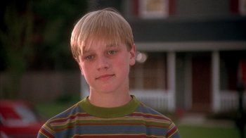 Movie still from “Now and Then” (1995), directed by Lesli Linka Glatter – A young boy with blonde hair wearing a striped shirt; Close Up shot, Low angle