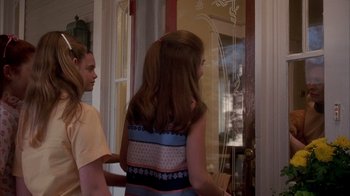 Movie still from “Now and Then” (1995), directed by Lesli Linka Glatter – A girl and a boy standing in front of a glass door; Medium shot, Over the shoulder angle