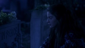 Movie still from “Now and Then” (1995), directed by Lesli Linka Glatter – A young woman sitting in a dark room; Close Up shot, Over the shoulder angle