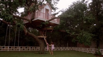 Movie still from “Now and Then” (1995), directed by Lesli Linka Glatter – A woman standing on a ladder next to a tree house; Extreme Wide shot, Low angle