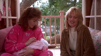 Movie still from “Now and Then” (1995), directed by Lesli Linka Glatter – Two women sitting on a porch holding a baby; Medium shot, Over the shoulder angle