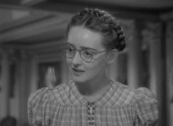 Movie still from “Now, Voyager” (1942), directed by Irving Rapper – An old photo of a woman wearing glasses; Close Up shot, High angle
