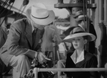 Movie still from “Now, Voyager” (1942), directed by Irving Rapper – A man and a woman sitting on a boat in the water; Medium shot, High angle
