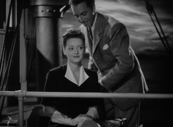 Movie still from “Now, Voyager” (1942), directed by Irving Rapper – A man and a woman are standing next to each other; Medium shot, High angle