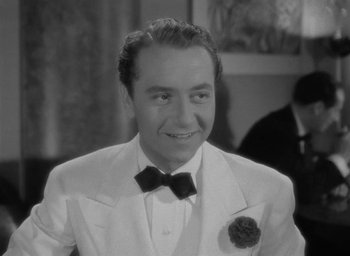 Movie still from “Now, Voyager” (1942), directed by Irving Rapper – A man wearing a suit and a bow tie; Close Up shot, High angle