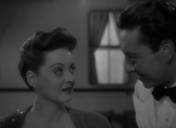 Movie still from “Now, Voyager” (1942), directed by Irving Rapper – A man and a woman looking at one another; Close Up shot, Over the shoulder angle