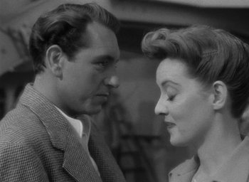 Movie still from “Now, Voyager” (1942), directed by Irving Rapper – An old photo of a man and a woman looking at each other; Close Up shot, Over the shoulder angle