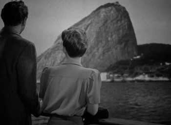 Movie still from “Now, Voyager” (1942), directed by Irving Rapper – Two people looking out over a body of water; Medium shot, High angle