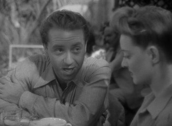 Movie still from “Now, Voyager” (1942), directed by Irving Rapper – A man and a woman sitting at a table talking to each other; Close Up shot, Over the shoulder angle