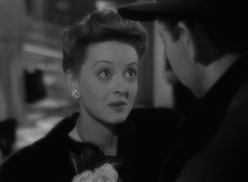 Movie still from “Now, Voyager” (1942), directed by Irving Rapper – An old black and white photo of a man and a woman; Close Up shot, Over the shoulder angle