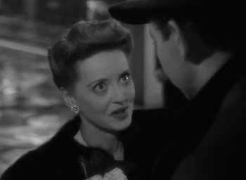 Movie still from “Now, Voyager” (1942), directed by Irving Rapper – An older woman talking to a younger man in a suit; Close Up shot, High angle
