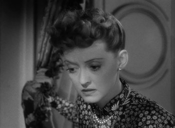 Movie still from “Now, Voyager” (1942), directed by Irving Rapper – An old photo of a woman in a black and white photo; Close Up shot, High angle