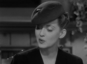 Movie still from “Now, Voyager” (1942), directed by Irving Rapper – A black and white photo of a woman wearing a hat; Close Up shot, Low angle