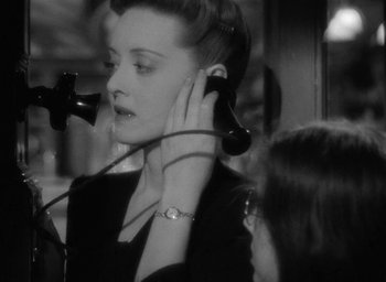 Movie still from “Now, Voyager” (1942), directed by Irving Rapper – A woman holding a phone up to her ear; Close Up shot, High angle