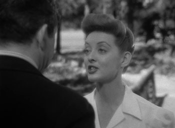 Movie still from “Now, Voyager” (1942), directed by Irving Rapper – An old photo of a woman talking to a man; Close Up shot, Over the shoulder angle