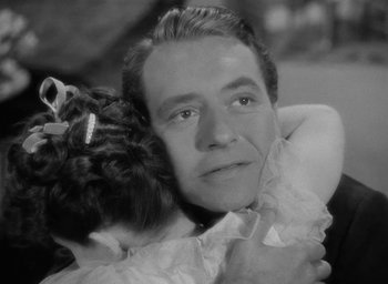 Movie still from “Now, Voyager” (1942), directed by Irving Rapper – A man and a little girl hugging each other; Close Up shot, Over the shoulder angle