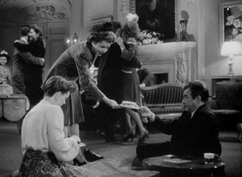 Movie still from “Now, Voyager” (1942), directed by Irving Rapper – An old black and white photo of a man and a woman; Wide shot, High angle