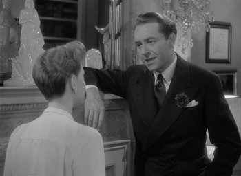 Movie still from “Now, Voyager” (1942), directed by Irving Rapper – An old photo of a man and a young woman; Medium shot, Over the shoulder angle