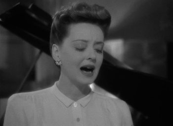 Movie still from “Now, Voyager” (1942), directed by Irving Rapper – An old black and white photo of a woman crying; Close Up shot, High angle