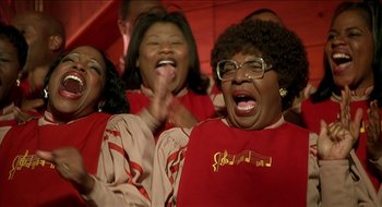 Movie still from “Nutty Professor II: The Klumps” (2000), directed by Peter Segal – A group of people that are singing together; Close Up shot, Low angle