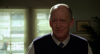 Movie still from “Nutty Professor II: The Klumps” (2000), directed by Peter Segal – An older man wearing a tie and a sweater vest; Close Up shot, Low angle