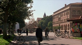 Movie still from “Nutty Professor II: The Klumps” (2000), directed by Peter Segal – A group of bicyclists riding down a street; Extreme Wide shot, High angle