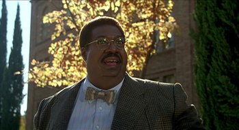 Movie still from “Nutty Professor II: The Klumps” (2000), directed by Peter Segal – A person wearing glasses and a bow tie; Close Up shot, Low angle