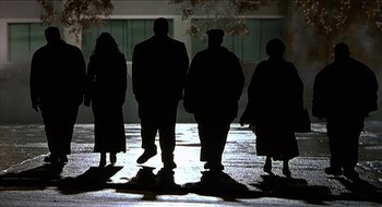 Movie still from “Nutty Professor II: The Klumps” (2000), directed by Peter Segal – A group of people standing on a sidewalk; Wide shot, Low angle