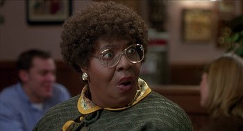 Movie still from “Nutty Professor II: The Klumps” (2000), directed by Peter Segal – An older woman wearing glasses looking surprised; Close Up shot, Over the shoulder angle