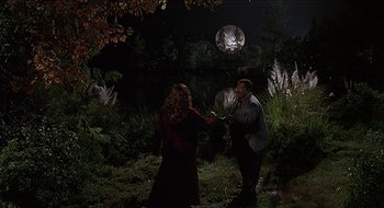 Movie still from “Nutty Professor II: The Klumps” (2000), directed by Peter Segal – A man and a woman in a field at night; Wide shot, Over the shoulder angle