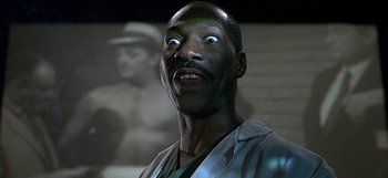 Movie still from “Nutty Professor II: The Klumps” (2000), directed by Peter Segal – An african american man looking up at the camera; Close Up shot, Low angle
