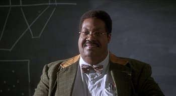 Movie still from “Nutty Professor II: The Klumps” (2000), directed by Peter Segal – A person wearing glasses and a bow tie; Close Up shot, Low angle