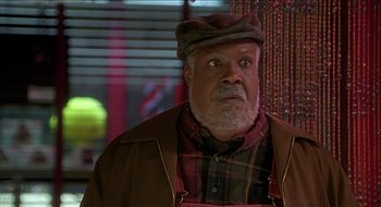 Movie still from “Nutty Professor II: The Klumps” (2000), directed by Peter Segal – An older man wearing a hat and a plaid shirt; Close Up shot, Low angle