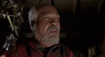 Movie still from “Nutty Professor II: The Klumps” (2000), directed by Peter Segal – An older man wearing a red and black plaid shirt; Close Up shot, Low angle