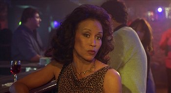 Movie still from “Nutty Professor II: The Klumps” (2000), directed by Peter Segal – A person wearing a leopard print dress; Close Up shot, Low angle