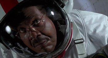 Movie still from “Nutty Professor II: The Klumps” (2000), directed by Peter Segal – A man in a spacesuit with a helmet on his head; Close Up shot, Low angle