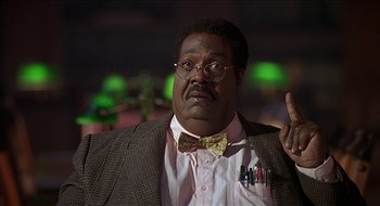 Movie still from “Nutty Professor II: The Klumps” (2000), directed by Peter Segal – A person wearing glasses and a bow tie; Close Up shot, Low angle