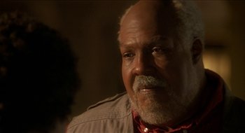 Movie still from “Nutty Professor II: The Klumps” (2000), directed by Peter Segal – An older man wearing a red shirt is looking at the camera; Close Up shot, Low angle