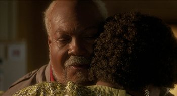 Movie still from “Nutty Professor II: The Klumps” (2000), directed by Peter Segal – An older man holding a young girl's face; Close Up shot, Over the shoulder angle