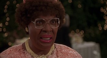 Movie still from “Nutty Professor II: The Klumps” (2000), directed by Peter Segal – An older woman wearing glasses and a pink dress; Close Up shot, Low angle