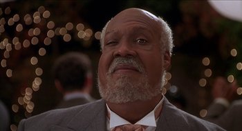 Movie still from “Nutty Professor II: The Klumps” (2000), directed by Peter Segal – An older man in a suit and tie looking upward; Close Up shot, Low angle