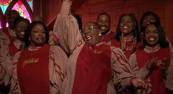 Movie still from “Nutty Professor II: The Klumps” (2000), directed by Peter Segal – A group of people standing next to each other; Medium shot, Low angle