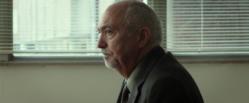Movie still from “Oculus” (2013), directed by Mike Flanagan – An older man wearing a suit and tie looking out a window; Close Up shot, Over the shoulder angle