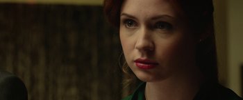 Movie still from “Oculus” (2013), directed by Mike Flanagan – A person wearing a green shirt; Close Up shot, Over the shoulder angle