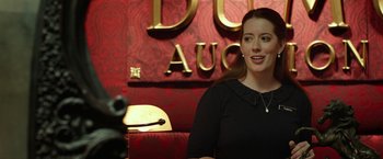 Movie still from “Oculus” (2013), directed by Mike Flanagan – A woman in a black dress sitting in front of a microphone; Close Up shot, Over the shoulder angle